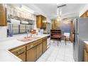 Functional kitchen with stainless steel appliances, tile flooring, and ample counter space at 1301 62Nd S Ter, St Petersburg, FL 33705