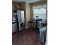 Functional kitchen area with stainless steel refrigerator and a cozy breakfast table and chairs at 13020 Lorna Pl, Tampa, FL 33618