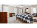 Spacious bedroom with soft carpet, a ceiling fan, and classic wood furniture at 13040 Hanley Dr, Spring Hill, FL 34609