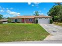 Charming single-story home with a well-manicured lawn, a two-car garage, and inviting curb appeal at 13040 Hanley Dr, Spring Hill, FL 34609