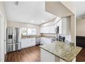 Modern kitchen with stainless steel appliances, granite counters, and ample cabinet space at 13040 Hanley Dr, Spring Hill, FL 34609
