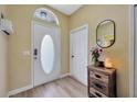Inviting entryway featuring wood-look flooring and an oval glass accent in the front door for natural light at 1535 Crossvine Ct, Trinity, FL 34655