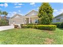 Charming single-story home with a three-car garage and well-manicured landscaping at 17731 Bright Wheat Dr, Lithia, FL 33547