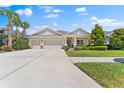 Charming single-story home with a three-car garage and well-manicured landscaping at 17731 Bright Wheat Dr, Lithia, FL 33547