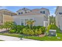 Lush landscaping adds natural beauty to this home's exterior, complete with privacy fence in the background at 18017 Ramble On Way, Land O Lakes, FL 34638