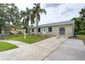 The home features a well-maintained lawn, an extra long driveway and a lovely, neat exterior at 1980 Taylor Lake Cir, Largo, FL 33778