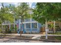 Charming two-story home with a welcoming front porch, blue exterior, and a manicured front yard at 2130 W Spruce St, Tampa, FL 33607