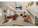 Spacious living room with high ceilings, a fireplace, and staircase to the second level at 2175 Oak Forest Ln, Palm Harbor, FL 34683