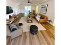 Spacious living room with tan leather sectional, wood floors, decorative rug, and stylish decor at 2400 13Th S Ave, St Petersburg, FL 33712