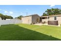 Expansive backyard featuring lush artificial turf, a spa, and a fenced perimeter at 2715 9Th N Ave, St Petersburg, FL 33713