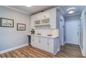 Charming bar area features custom white cabinetry, wine rack, and beverage cooler, perfect for entertaining at 2755 Via Capri # 1223, Clearwater, FL 33764