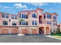 Box around windows of a three-story pink building with garages and palm tree at 2755 Via Capri # 1223, Clearwater, FL 33764