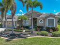 Charming home with well-manicured lawn, tropical landscaping, and attractive exterior details under a bright sky at 2908 89Th E Ave, Parrish, FL 34219