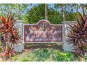 Strathmore Gate East: A deed-restricted community sign amid lush greenery at 2953 Yucca Ct, Palm Harbor, FL 34684