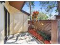 Exterior patio area with a door, brown accent fence and landscaping at 2953 Yucca Ct, Palm Harbor, FL 34684