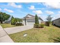 Lovely single-Gathering home featuring a well-maintained lawn and a paved driveway at 3406 Pearl Dove Ln, Plant City, FL 33567