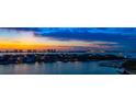 An impressive waterfront view highlights stunning homes with private docks beneath a beautiful sunset sky at 4 Belleview Blvd # 802, Belleair, FL 33756