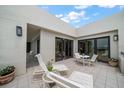 A serene outdoor balcony provides a relaxing retreat with cushioned chairs and a peek at the view at 4 Belleview Blvd # 802, Belleair, FL 33756