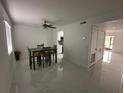 Bright dining area with modern light fixture, tile flooring, and open access to the kitchen area at 4022 Cortez Dr # A, Tampa, FL 33614