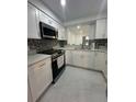 Updated kitchen features stainless steel appliances, white cabinets, and granite countertops at 4022 Cortez Dr # A, Tampa, FL 33614