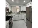 Bright kitchen features stainless steel appliances, white cabinets, and granite countertops at 4022 Cortez Dr # A, Tampa, FL 33614