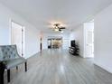 Bright living room featuring tile floors, ceiling fan, neutral paint and access to outdoor patio at 5806 Liverpool Dr, Tampa, FL 33615