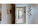 Hallway in building with a sunburst decoration, tile floor, and secured entry to the building at 7867 Sailboat Key S Blvd # 101, South Pasadena, FL 33707