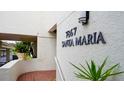 Close up of building sign '7867 Santa Maria' with tropical foliage and architectural details at 7867 Sailboat Key S Blvd # 101, South Pasadena, FL 33707