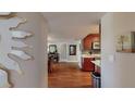 Hallway view leading to dining area and kitchen, featuring wood floors and neutral walls at 7867 Sailboat Key S Blvd # 101, South Pasadena, FL 33707