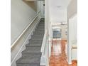 Interior view of the hallway with stairs, light walls, tiled flooring, and a glimpse of the living space beyond at 8101 Interbay Blvd # A, Tampa, FL 33616