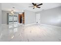 Spacious living room with bright marble floors and lots of natural light at 8240 Quail Rd, Seminole, FL 33777