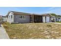 Charming single-Gathering home with a screened-in porch and stone accents on the facade at 8330 Moulton Dr, Port Richey, FL 34668