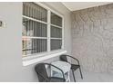 Close-up view of the front porch with seating, showcasing the stone accent wall at 8330 Moulton Dr, Port Richey, FL 34668