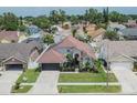 Lovely home with an attached garage, manicured front lawn, and mature landscaping at 8915 Hannigan Ct, Tampa, FL 33626