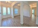 Open foyer with wood-look tile flooring and an arched entryway at 11240 Marvelwood, Brooksville, FL 34614