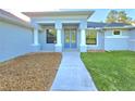 Inviting front entrance with a modern walkway and decorative stone feature at 11240 Marvelwood, Brooksville, FL 34614