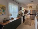 Bright kitchen features a large window, modern appliances, and custom-built floating shelves at 11376 119Th Ter, Largo, FL 33778