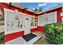 The exterior of the red commercial building is decorated with dog images on its windows at 126 Ridgewood Ave, Brandon, FL 33510