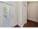 Bright entryway featuring wood-look floors, a closet, and a glass-paneled door leading to the exterior at 12831 White Bluff Rd, Hudson, FL 34669