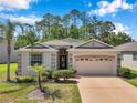 Charming single-story home with a well-maintained lawn, a two-car garage, and tasteful landscaping at 12831 White Bluff Rd, Hudson, FL 34669