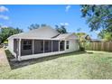 Expansive backyard with a screened-in porch, perfect for outdoor entertaining and relaxation at 13613 Laraway Dr, Riverview, FL 33579