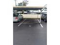 Assigned parking space with covered carport, ensuring protection and convenience for residents' vehicles at 1415 Doolittle Ln # 104, Dunedin, FL 34698