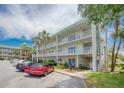Exterior view of building with parked cars and surrounding landscaping at 2071 Australia W Way # 59, Clearwater, FL 33763