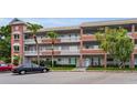 Condo exterior with balconies, brick accents, and convenient parking at 2460 Persian Dr # 54, Clearwater, FL 33763