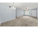 Spacious living room featuring carpet and a front door at 2460 Persian Dr # 54, Clearwater, FL 33763