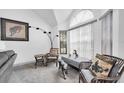 Bright seating area with large arched window, neutral colors, and decorative accents create a comfortable space at 3177 Montrose Pl, Palm Harbor, FL 34684