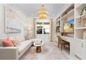 Stylish home office with custom built-ins, plush seating, modern decor, and ample natural light at 3923 Corsica Pl, Wesley Chapel, FL 33543