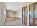 Inviting living room with neutral paint, wood-look flooring, and a bright window at 4012 Woodacre Ln, Tampa, FL 33624