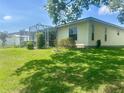 Expansive backyard featuring a screened enclosure, perfect for outdoor gatherings at 4074 Parkway Blvd, Land O Lakes, FL 34639