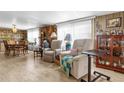 Comfortable living room featuring laminate flooring, relaxing recliners, and bright, natural light at 4314 12Th Street E Ct, Ellenton, FL 34222